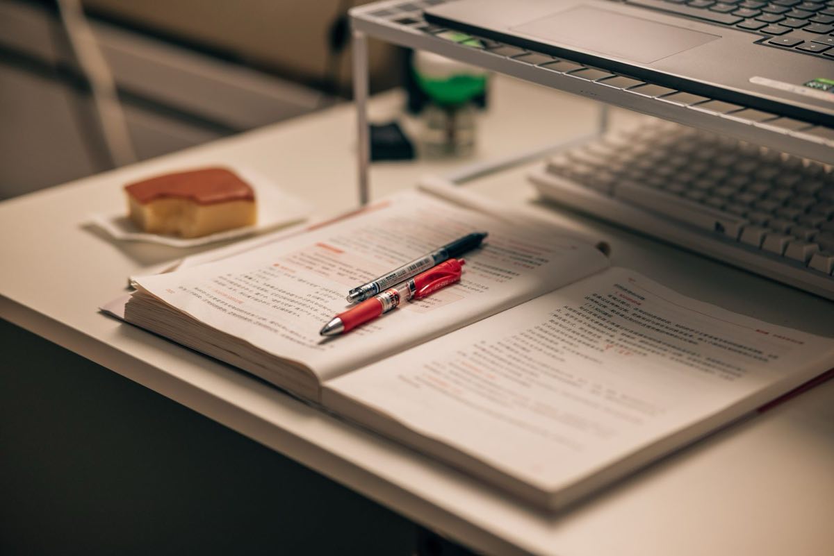 A working desk with paper and a lamp